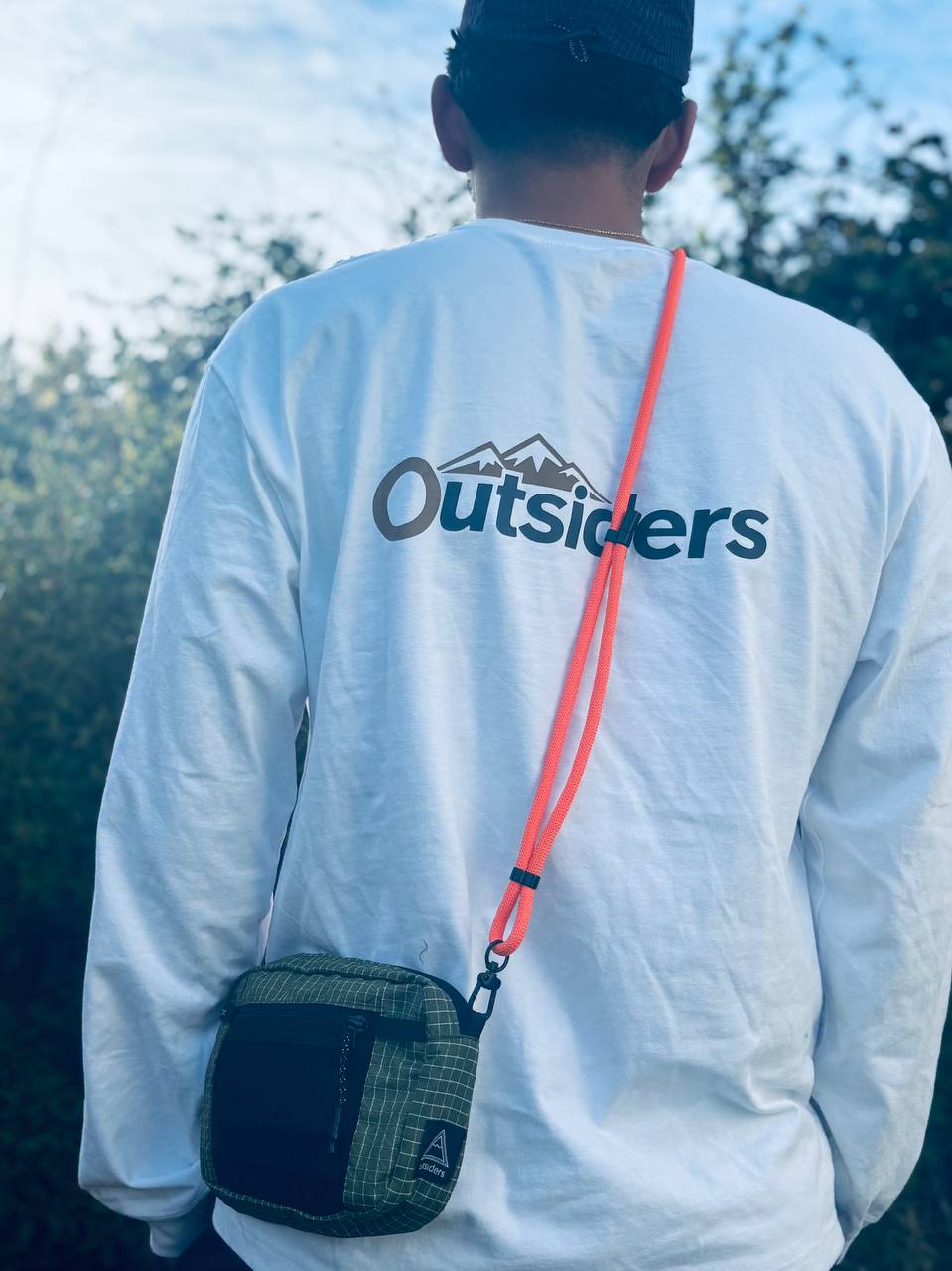 Outsiders MidMod bag with orange strap worn outside